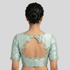 Light green blouse with floral embroidery on a plain background