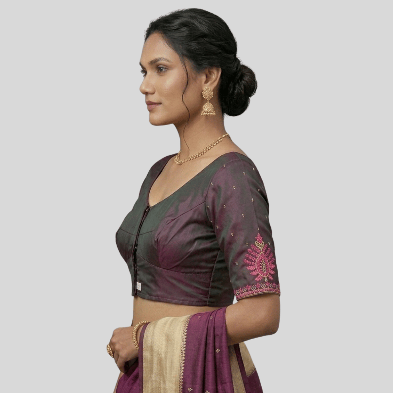 Woman wearing a traditional saree with a plain background