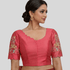 Woman wearing a pink blouse with intricate designs with Scallop embroidery