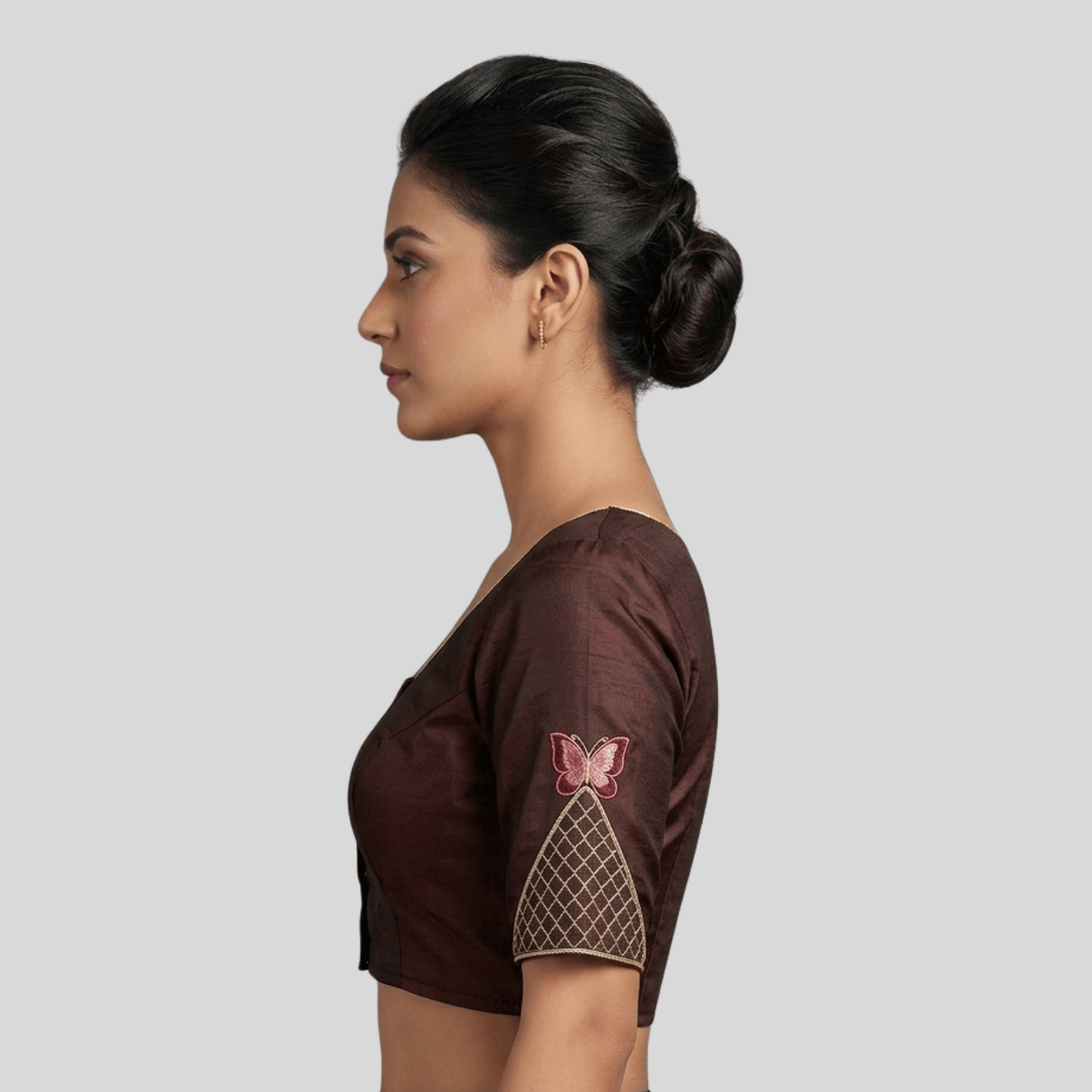 pink and gold butterfly embroidery on the sleeve,